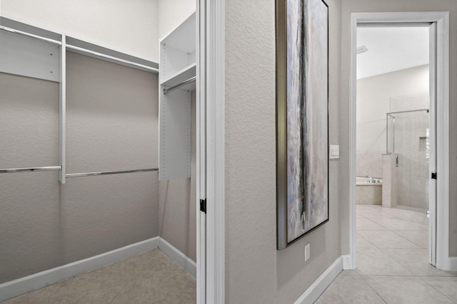 spacious closet featuring light tile patterned flooring