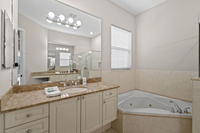 bathroom featuring vanity and shower with separate bathtub