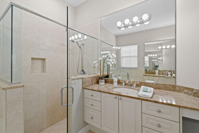 bathroom featuring vanity and a shower with door