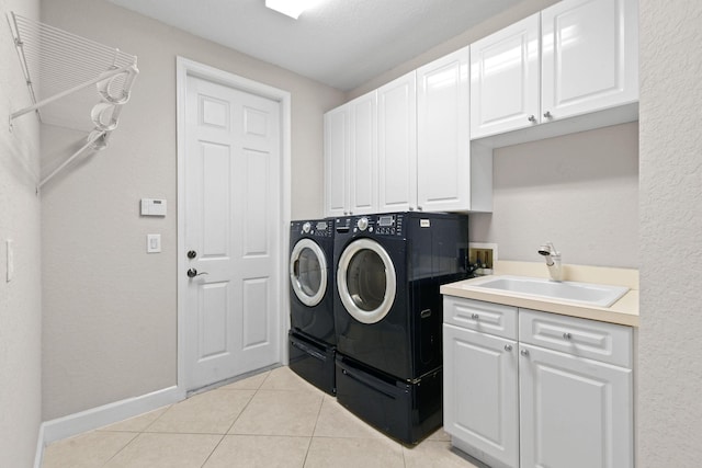 laundry area featuring sink, cabinets, independent washer and dryer, and light tile patterned flooring