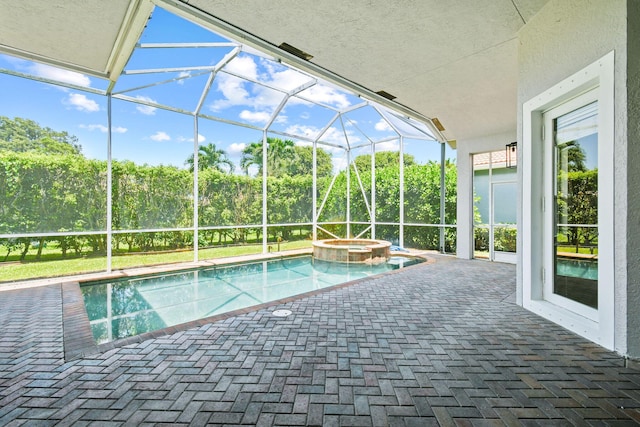 view of swimming pool with a lanai, a patio area, and an in ground hot tub