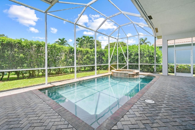 view of swimming pool featuring an in ground hot tub, a lanai, and a patio area