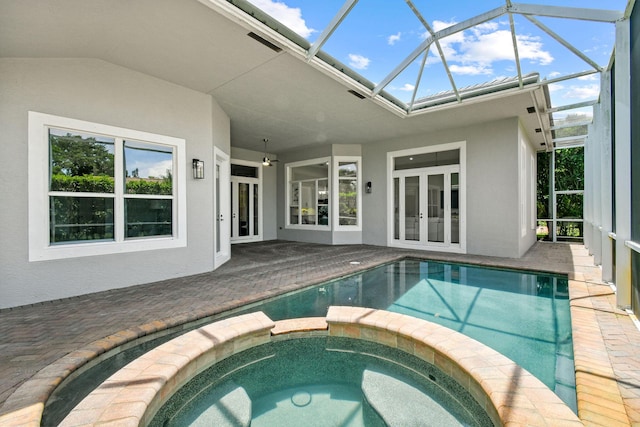 view of pool featuring a patio, a lanai, french doors, and an in ground hot tub