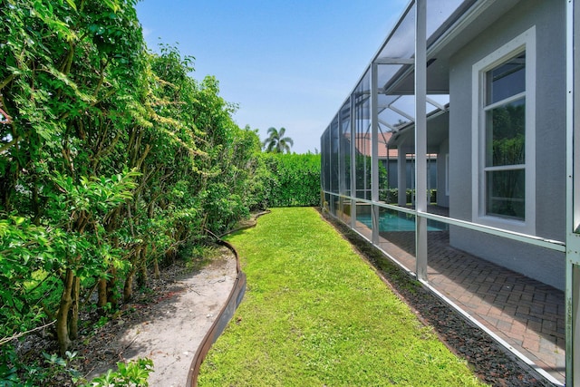 view of yard with glass enclosure