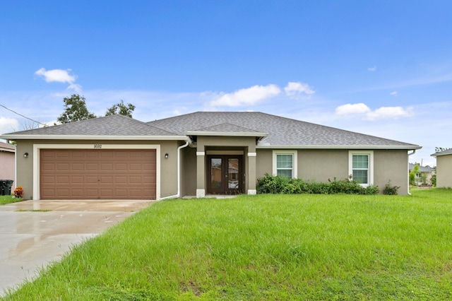 view of front of property with a front lawn and a garage