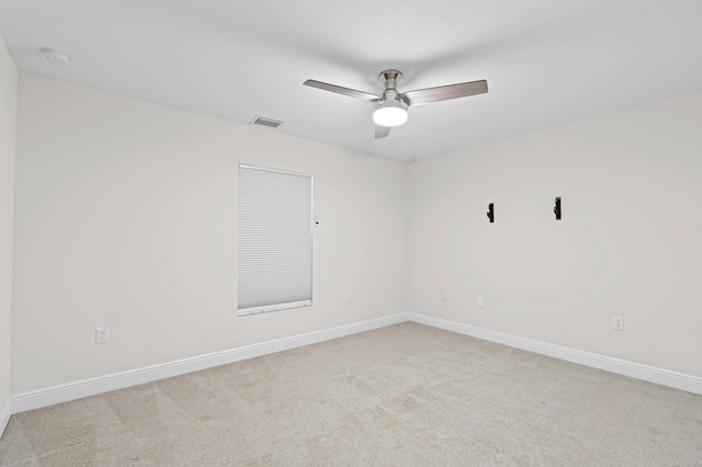 carpeted spare room with ceiling fan