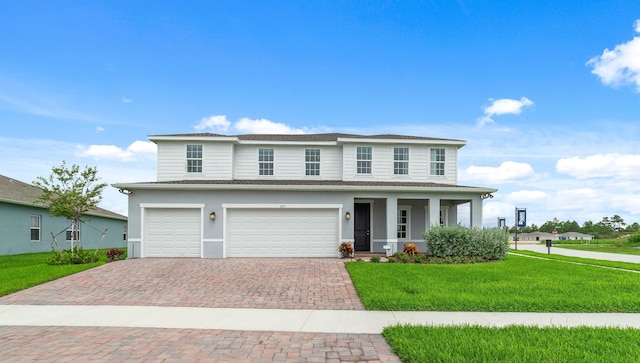 view of front of house featuring a garage and a front yard