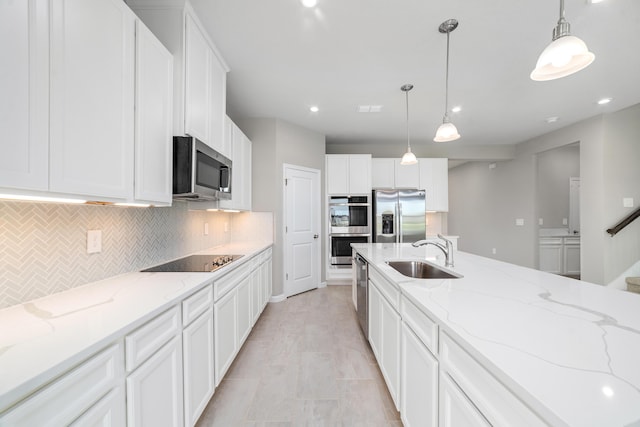 kitchen with white cabinetry, sink, hanging light fixtures, and appliances with stainless steel finishes