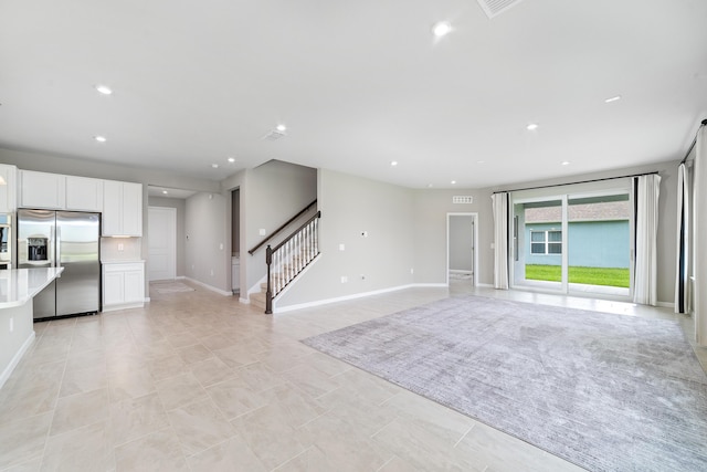 unfurnished living room with light tile patterned flooring