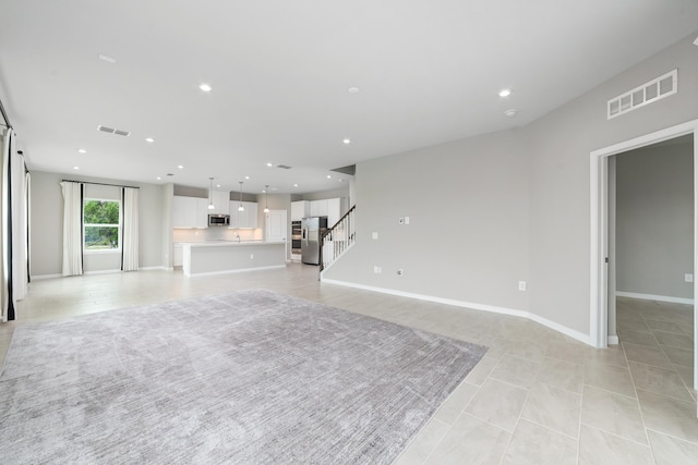 unfurnished living room featuring light tile patterned floors