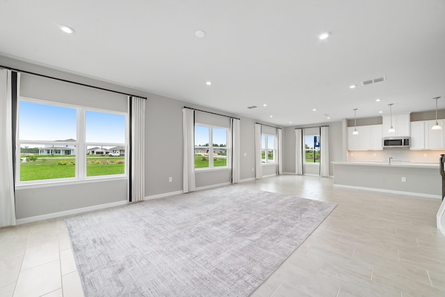 unfurnished living room featuring light tile patterned floors