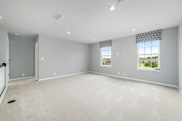 unfurnished room with light carpet