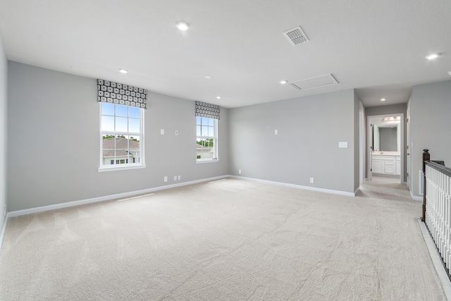 unfurnished living room featuring light carpet