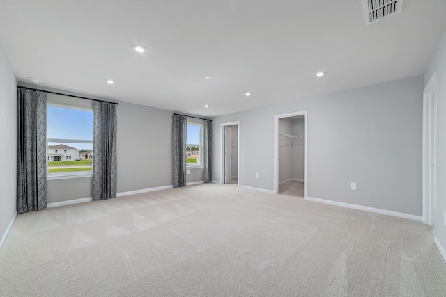 carpeted spare room with a healthy amount of sunlight