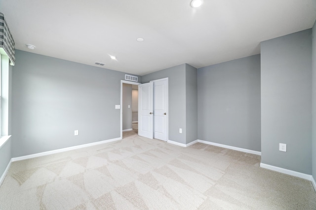 unfurnished bedroom with light carpet