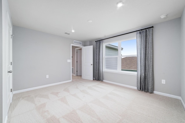 unfurnished bedroom with light colored carpet