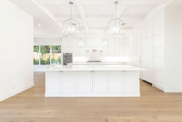 bathroom with hardwood / wood-style floors, beamed ceiling, and sink