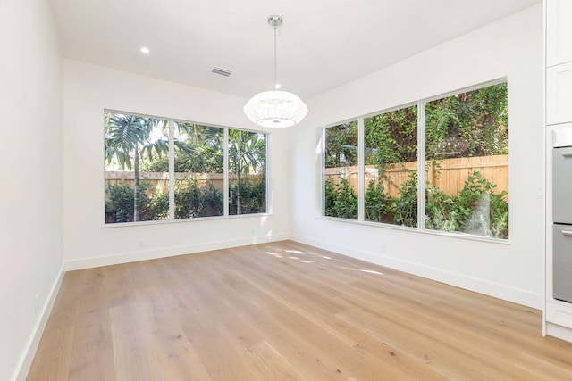 unfurnished dining area with light hardwood / wood-style floors