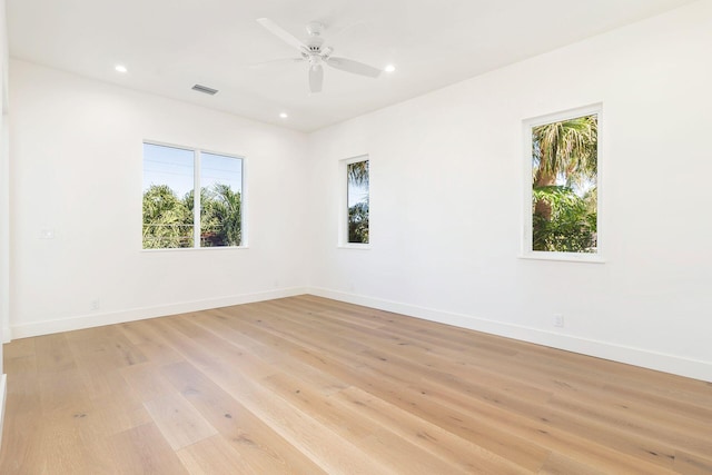 spare room with light hardwood / wood-style flooring and ceiling fan