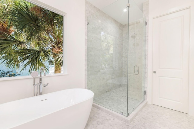 bathroom featuring tile patterned floors and separate shower and tub