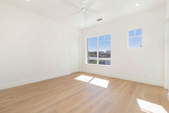 spare room featuring ceiling fan and light hardwood / wood-style flooring