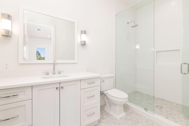 bathroom featuring tile patterned floors, vanity, toilet, and walk in shower