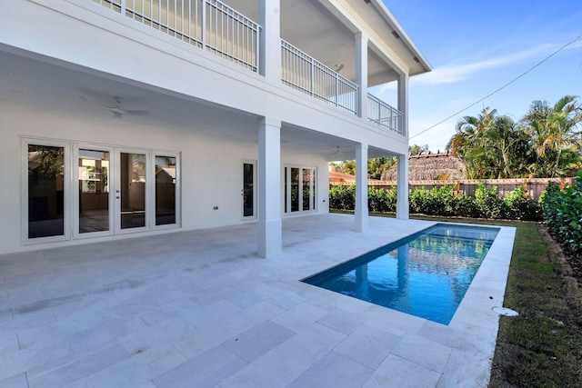 view of swimming pool with ceiling fan, french doors, and a patio