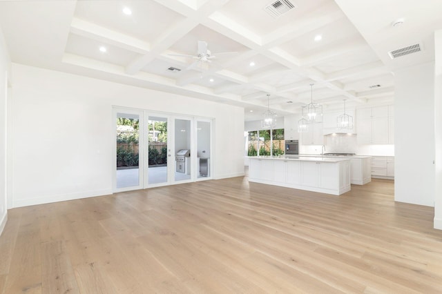 unfurnished living room featuring light hardwood / wood-style floors, plenty of natural light, and ceiling fan