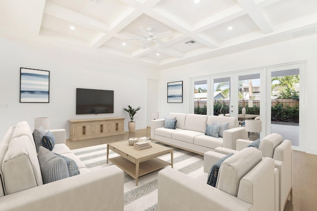 living room featuring ceiling fan, beam ceiling, french doors, and coffered ceiling