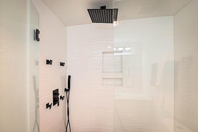 bathroom with tiled shower