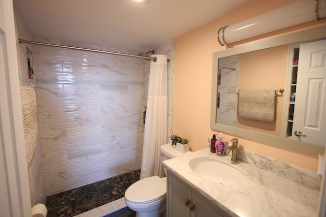 bathroom featuring curtained shower, toilet, and vanity