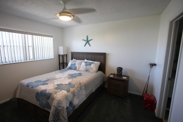 bedroom featuring ceiling fan and a textured ceiling