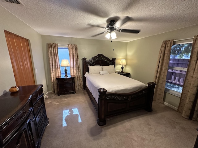 4634 Pine Grove Dr, Delray Beach, FL 33445 - bedroom with visible vents, baseboards, ceiling fan, a textured ceiling, and light colored carpet