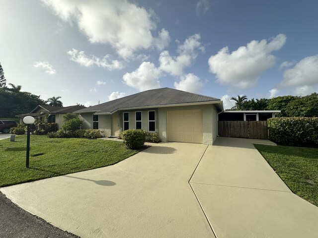 view of front of property with a garage and a front lawn