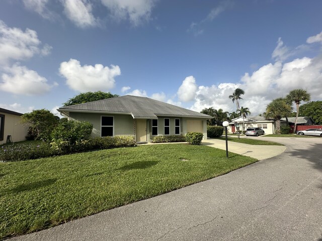 exterior space featuring a garage and a lawn