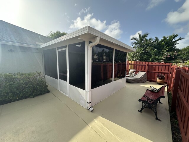 4634 Pine Grove Dr, Delray Beach, FL 33445 - view of patio featuring fence and a sunroom