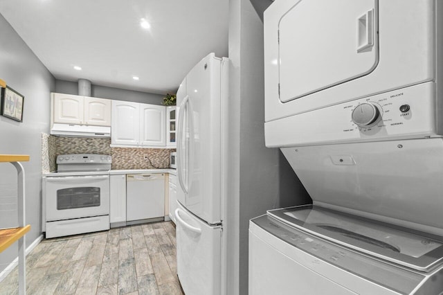 kitchen featuring decorative backsplash, white appliances, light hardwood / wood-style flooring, stacked washer / dryer, and white cabinetry