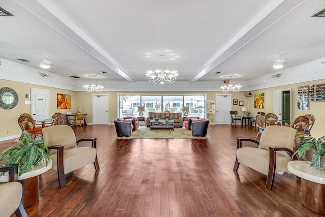 living room featuring beamed ceiling, wood-type flooring, and a textured ceiling