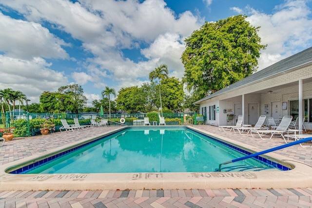 view of pool with ceiling fan and a patio area