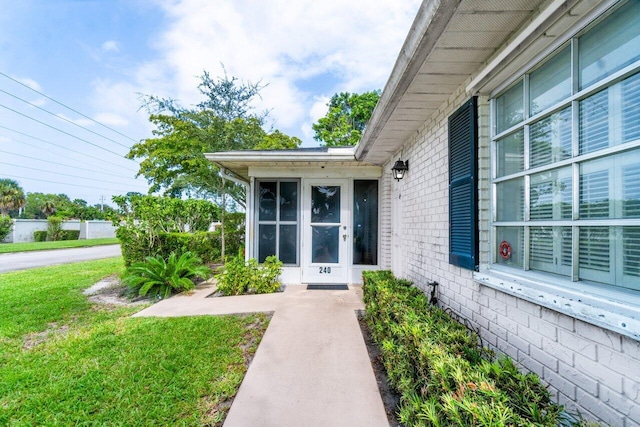 entrance to property with a yard