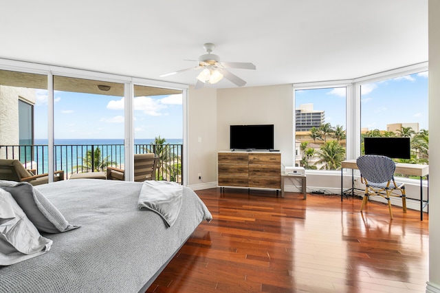 bedroom with access to outside, ceiling fan, a water view, and dark wood-type flooring