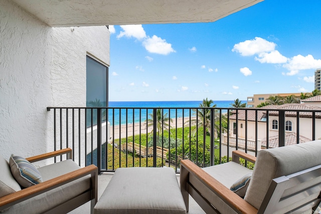 balcony with a beach view and a water view