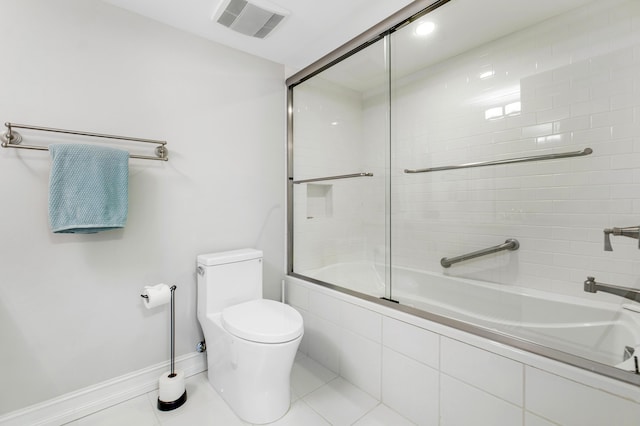 bathroom featuring tile patterned flooring, toilet, and shower / bath combination with glass door