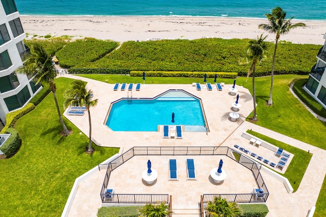 view of pool featuring a view of the beach and a water view