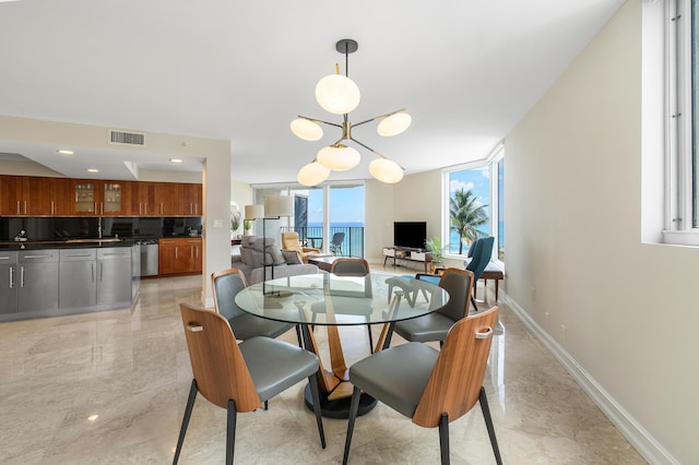 dining area with a chandelier and expansive windows