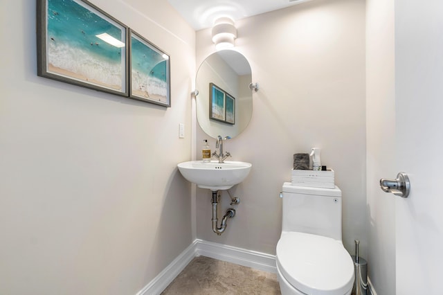 bathroom featuring sink and toilet