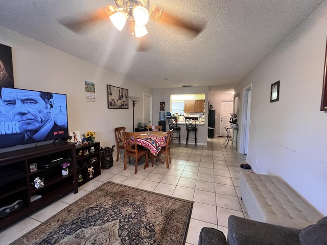 tiled living room featuring a textured ceiling