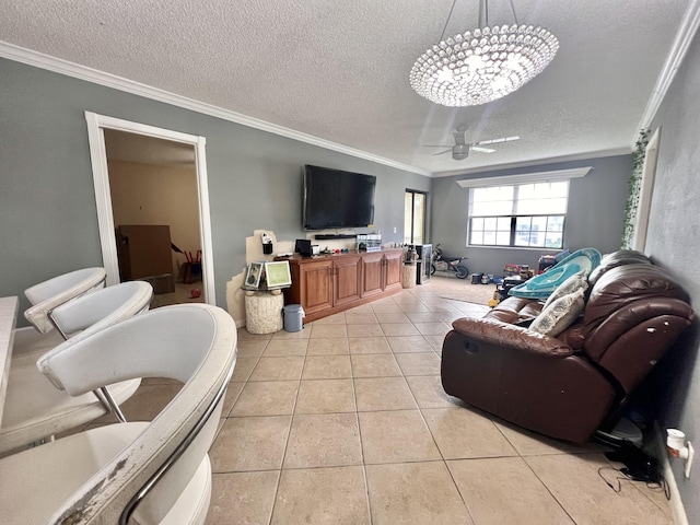 living room with crown molding, ceiling fan, a textured ceiling, and light tile patterned floors