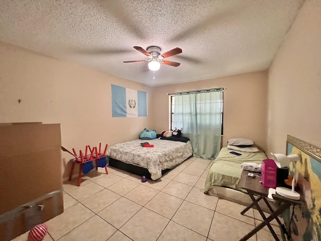 tiled bedroom featuring a textured ceiling and ceiling fan