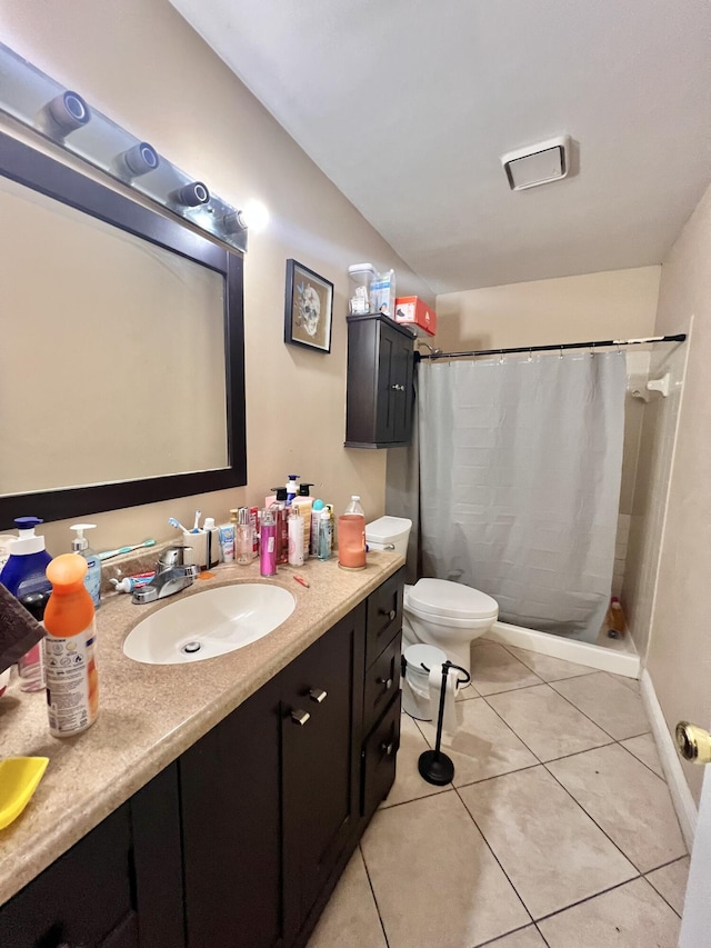 bathroom with vanity, tile patterned flooring, curtained shower, and toilet